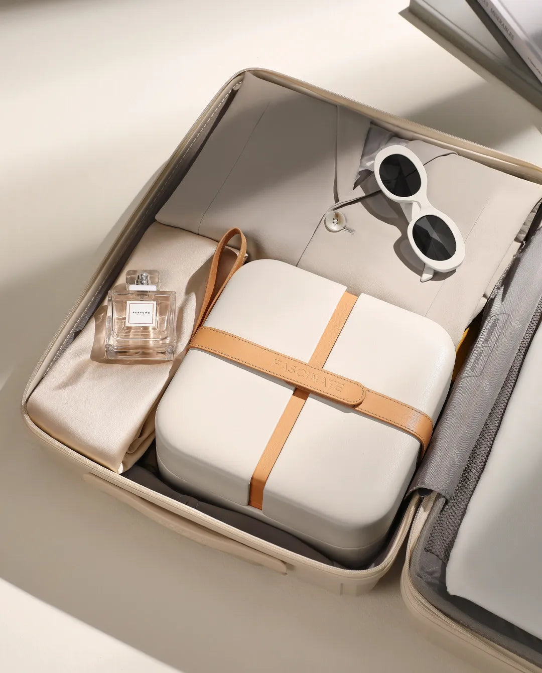 Beige travel makeup case packed inside a suitcase for organized cosmetics and beauty essentials on the go.